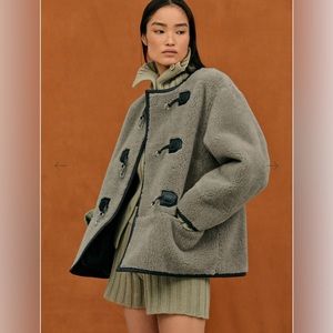 Source Unknown Chic mid-weight shearling coat with silver hardware details.